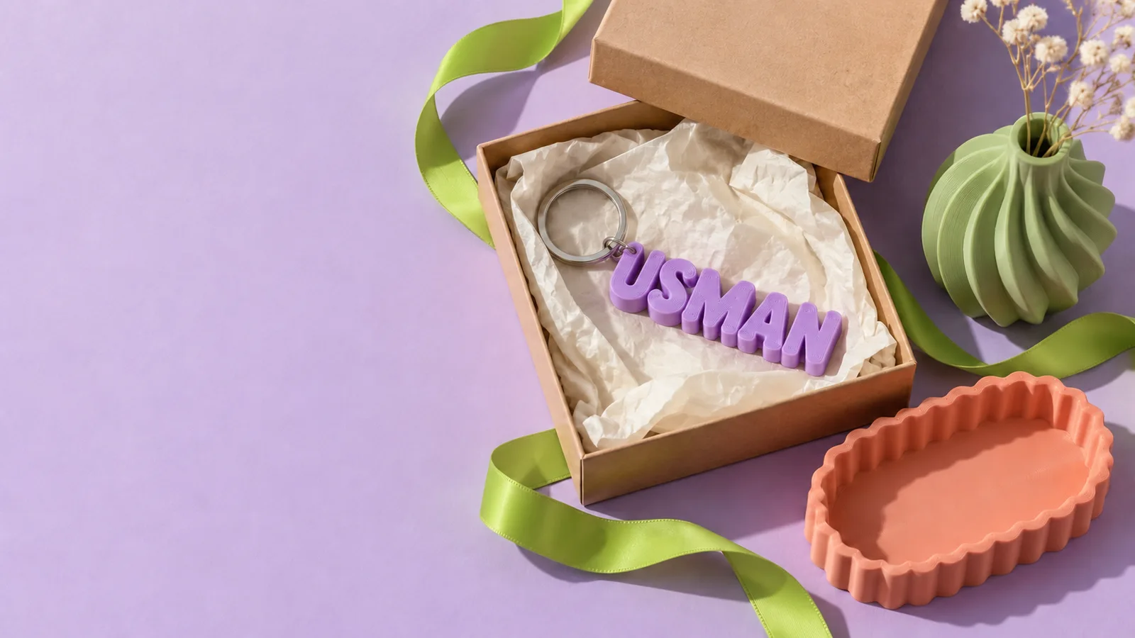 Concept gift styling with a personalised keyring, kraft box and colourful printed objects